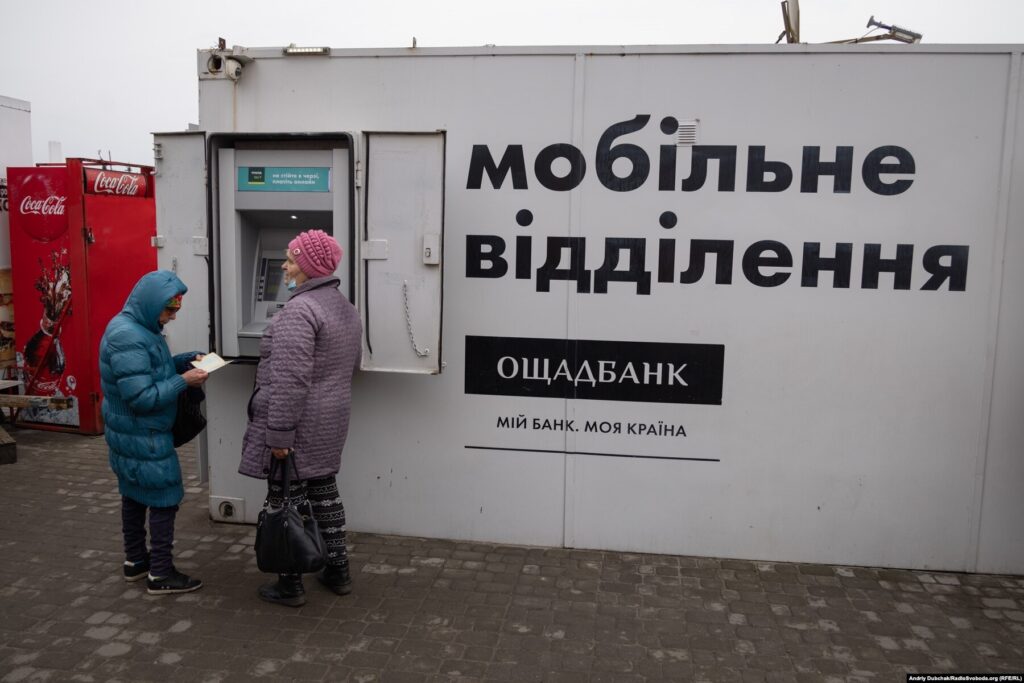 Donbas Frontliner / КПВВ Станиця Луганська. Жінки знімають готівку у мобільному банкоматі Ощадбанку, їх замінять на сучасніші модулі