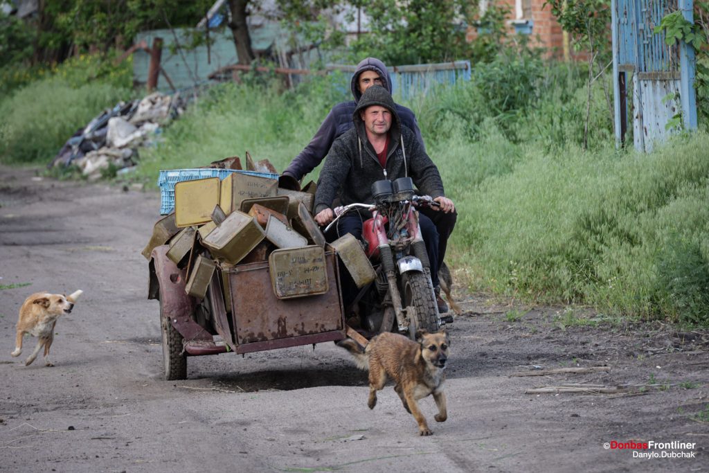 donbas frontliner, ukraine war, ruined area, Izum, locals, bike, shell box, russian invasion, photo