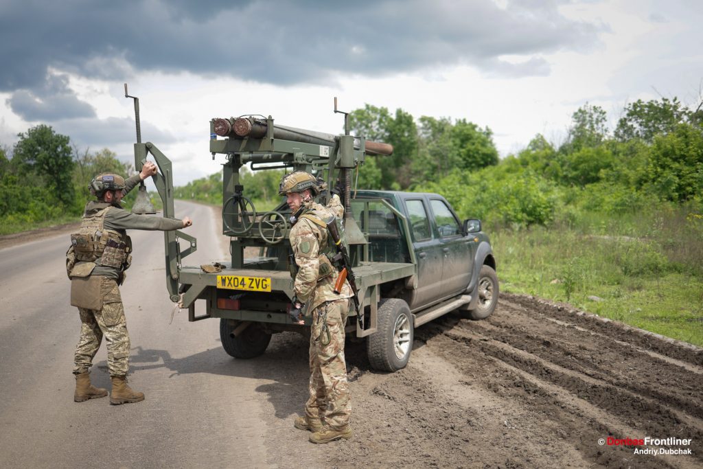 Donbas Frontliner, Ukraine war, artillery grad Partizan, Aidar battalion, soldiers setup the homemade Grad MLRS. The soldiers fix the car in place with the retractable feet to improve firing accuracy.
