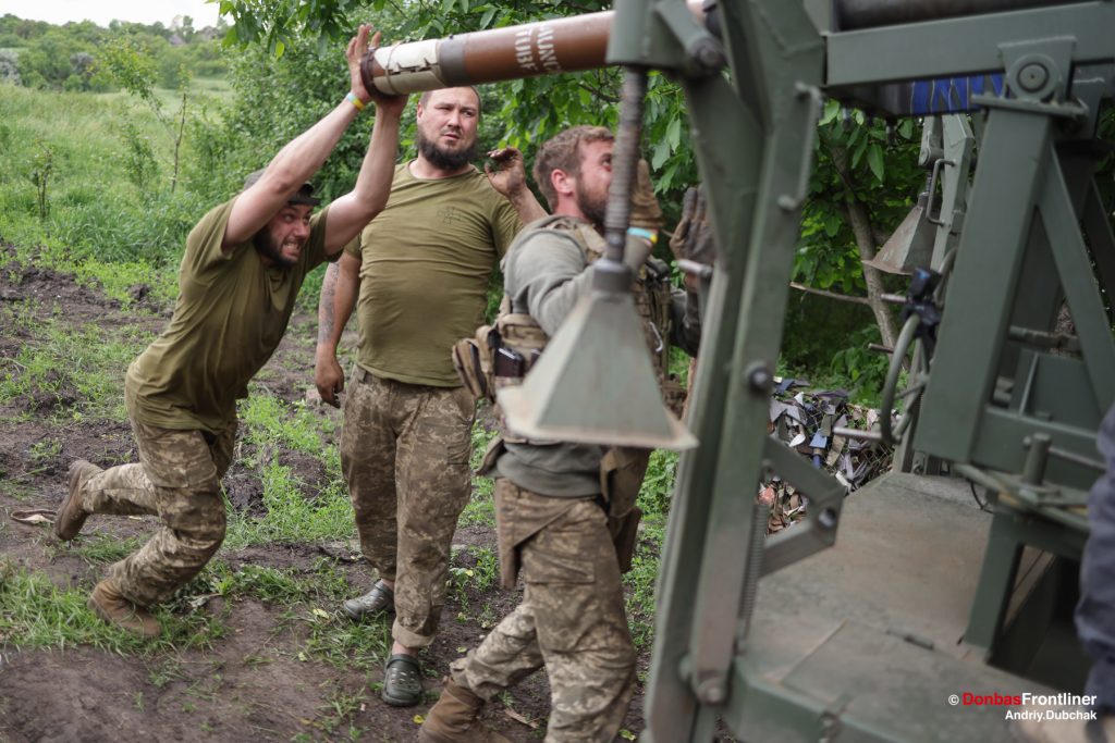 Donbas Frontliner, Ukraine war, artillery grad Partizan, Aidar battalion, soldiers reload MLRS rockets, Andriy Dubchak. The soldiers load a new batch of missiles into the Guerilla Grad.