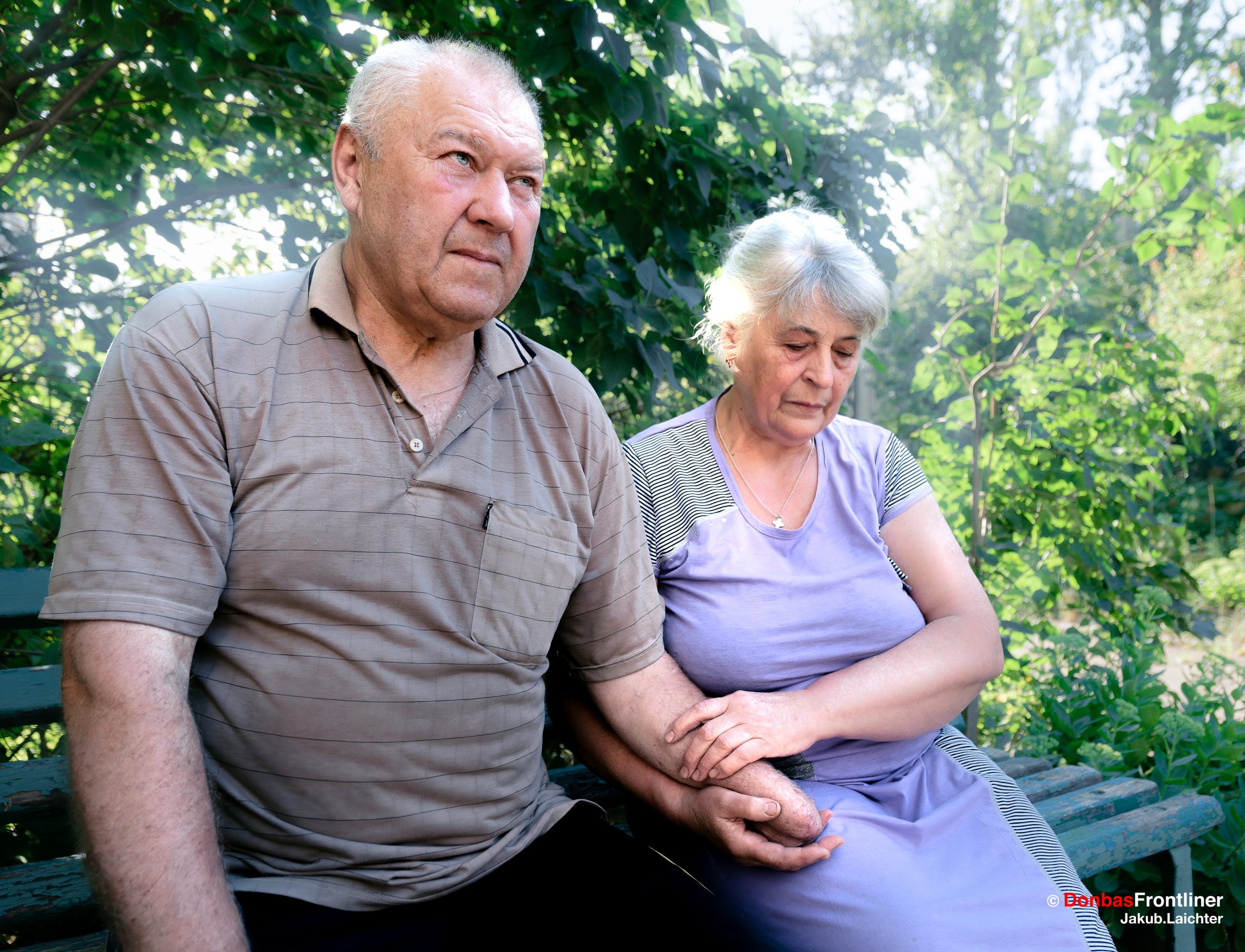 Valerii, 63, sits in front of his shelter with his wife Jevhdakia, in Avdiivka.
