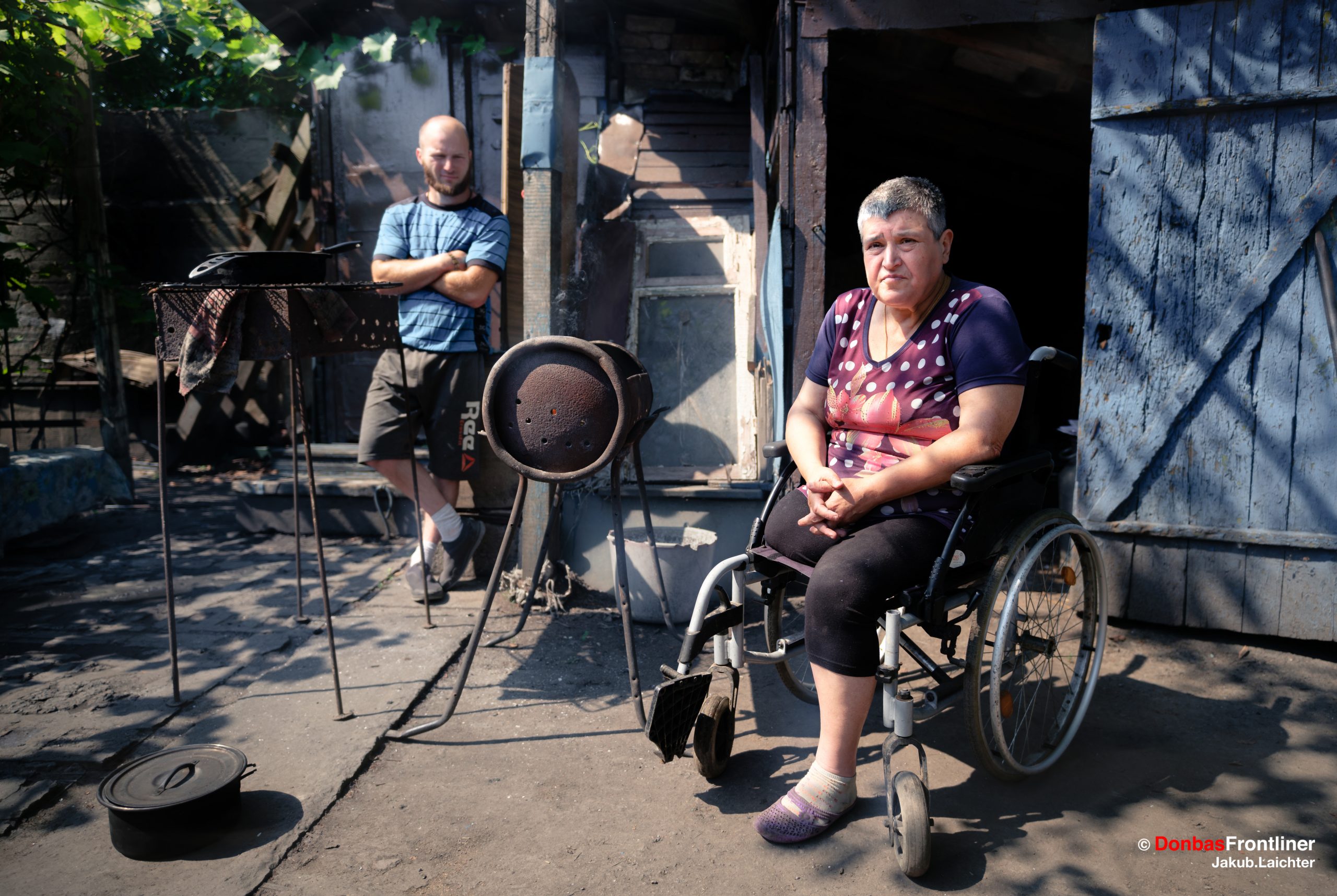 Donbas Frontliner / Iryna, 70, sits in front of her house.